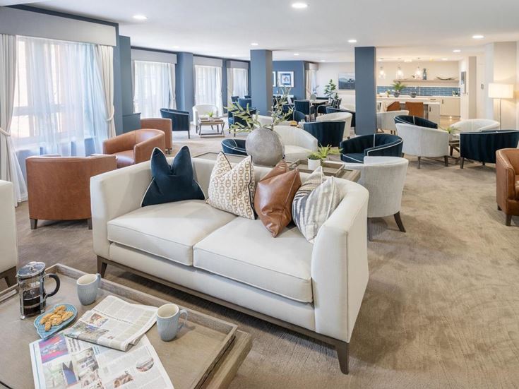 a large living room with a white couch and a table