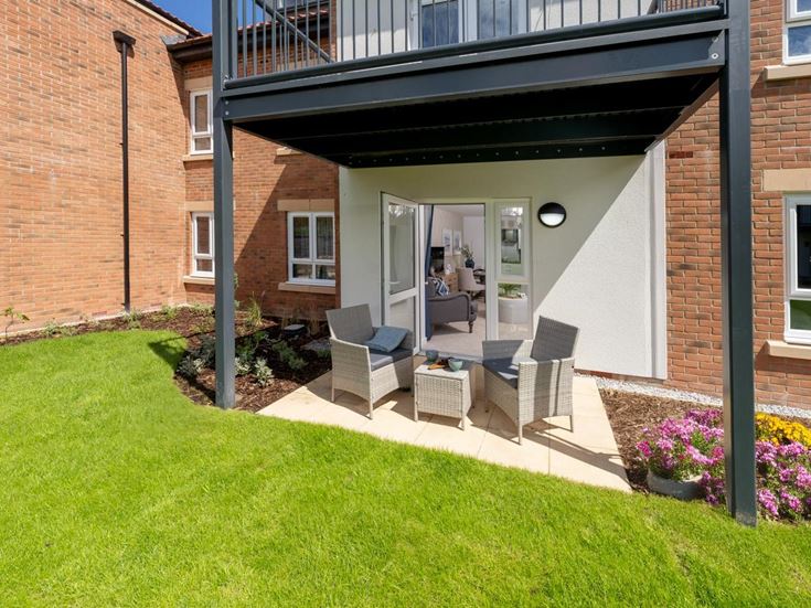 a house with a patio and a patio with a chair and a table