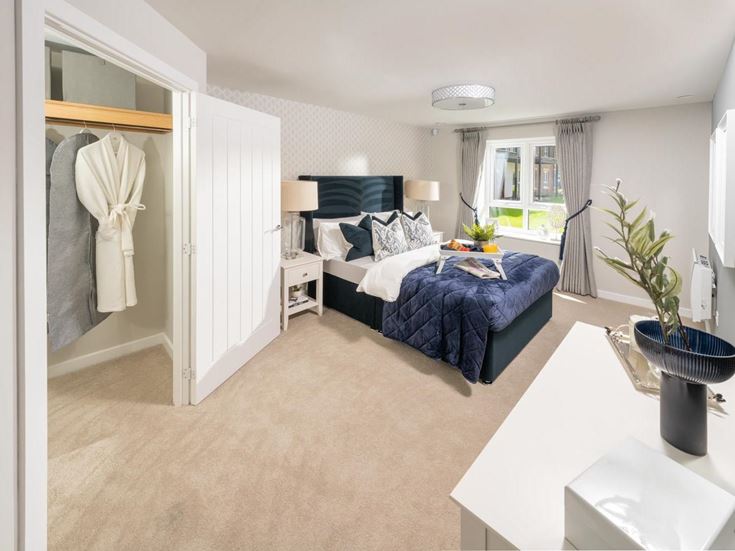 a bedroom with a bed and a desk