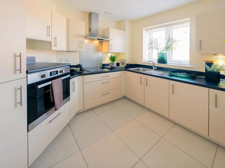 a kitchen with white tile