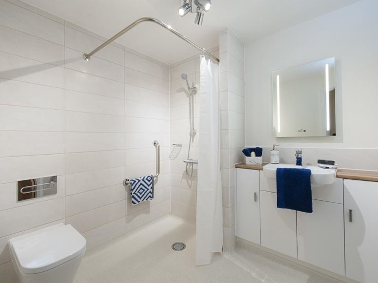 a bathroom with a shower unit and sink