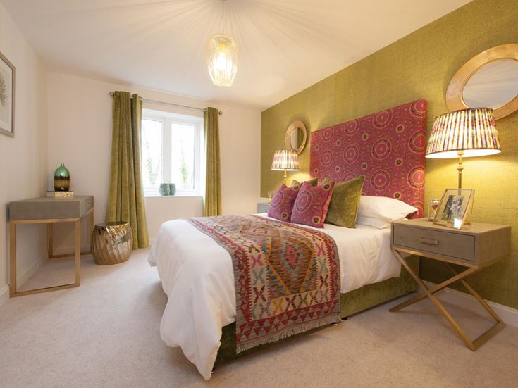 a bedroom with a bed and lamps