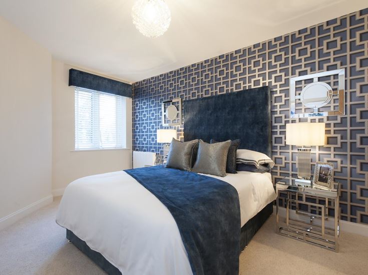 a bedroom with a bed and a mirror