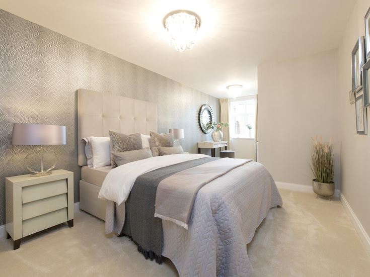 a bedroom with a bed and a lamp