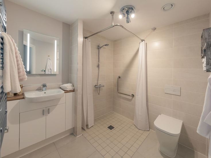 a bathroom with a shower and sink
