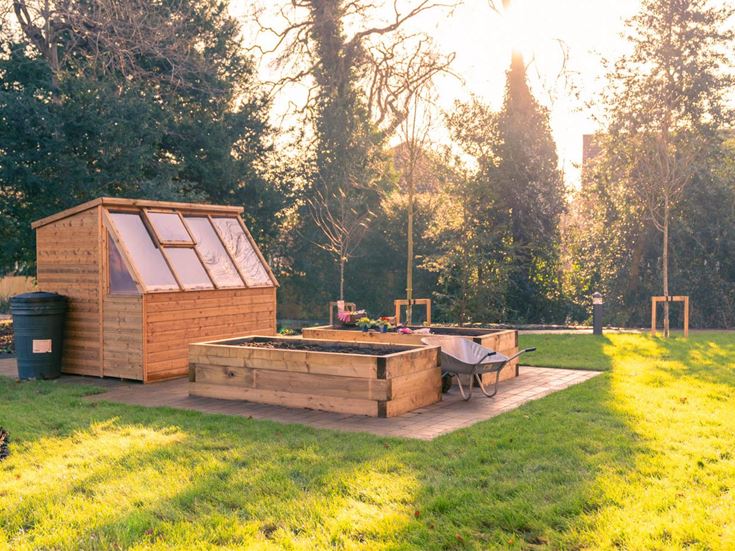 a small building with a bench in a park
