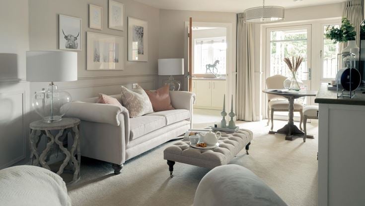 a living room with a white couch and a table