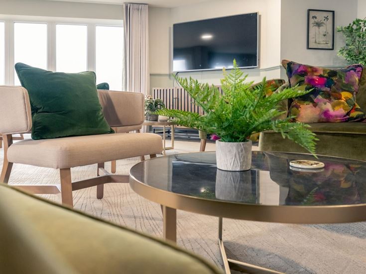 a living room with a table and chairs