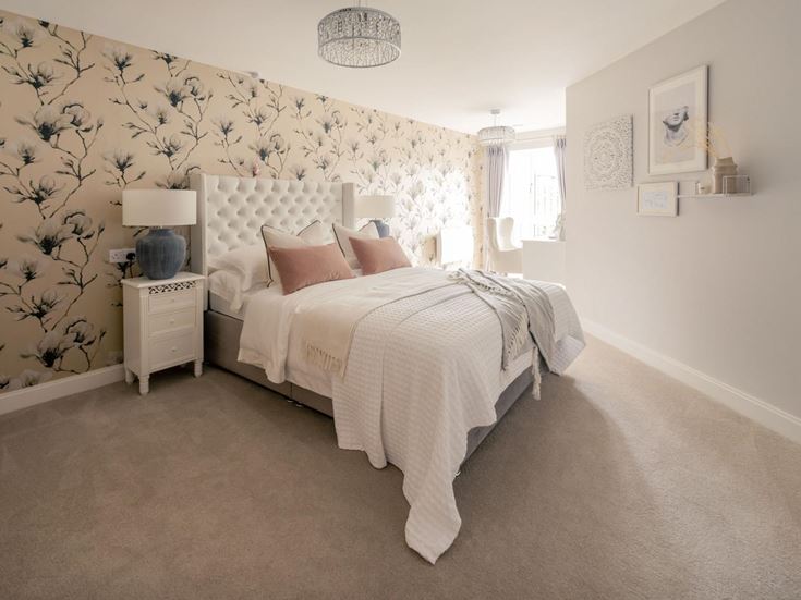 a bedroom with a bed and a lamp