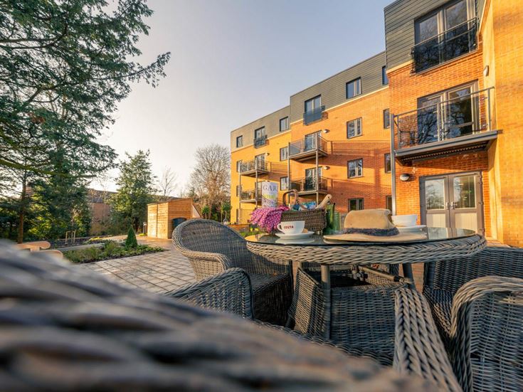 a patio with chairs and tables outside