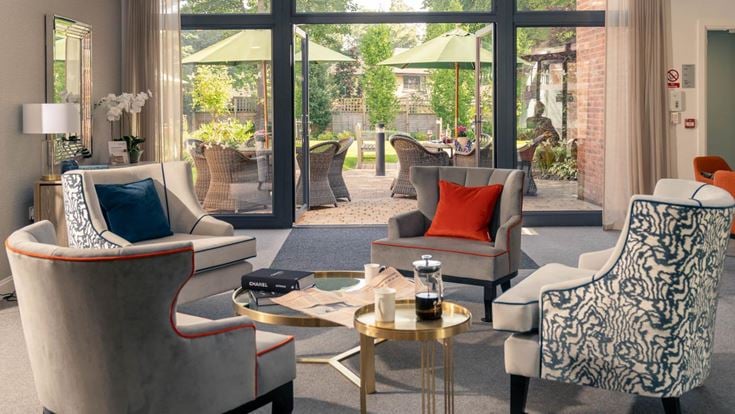 a living room with a table and chairs