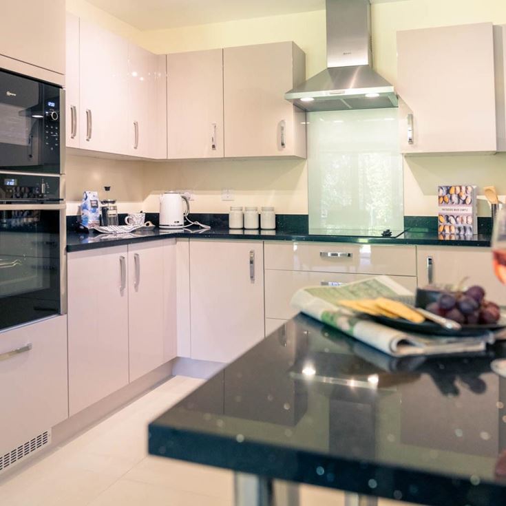 a kitchen with a glass of wine