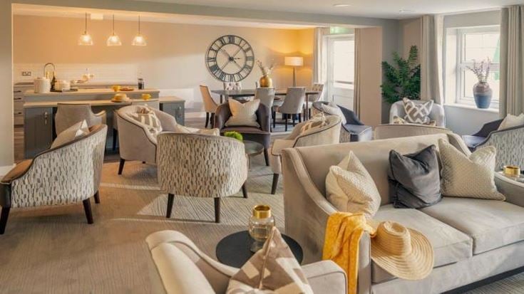 a living room with a couch and chairs