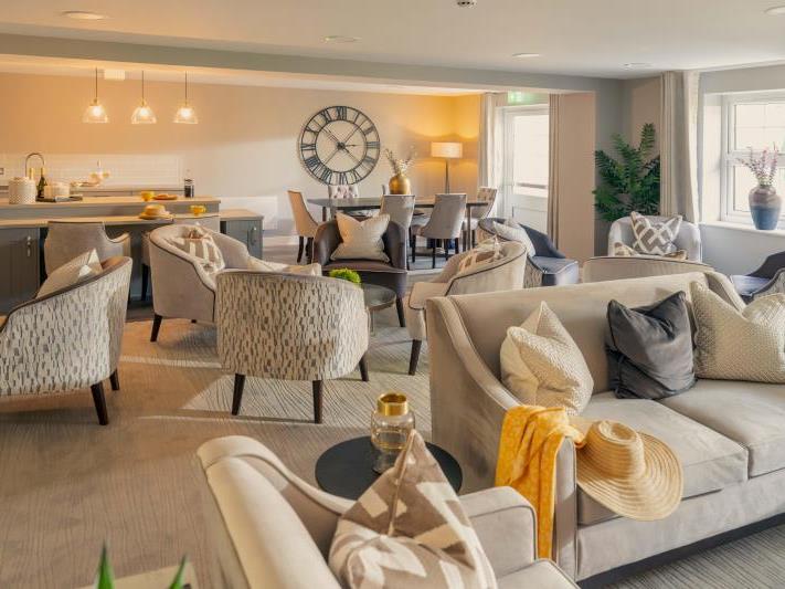 a living room with a couch and chairs