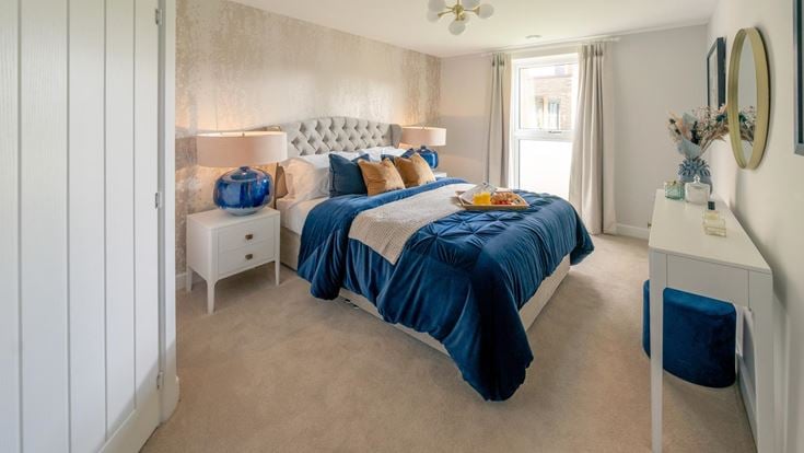 a bedroom with a bed and a desk