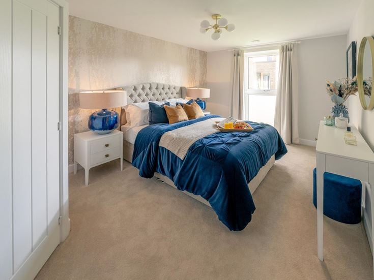 a bedroom with a bed and a desk