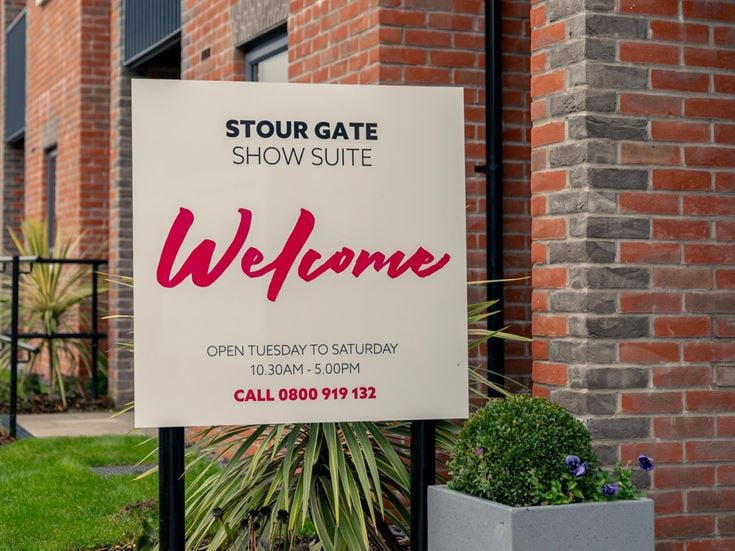 a sign in front of a brick building