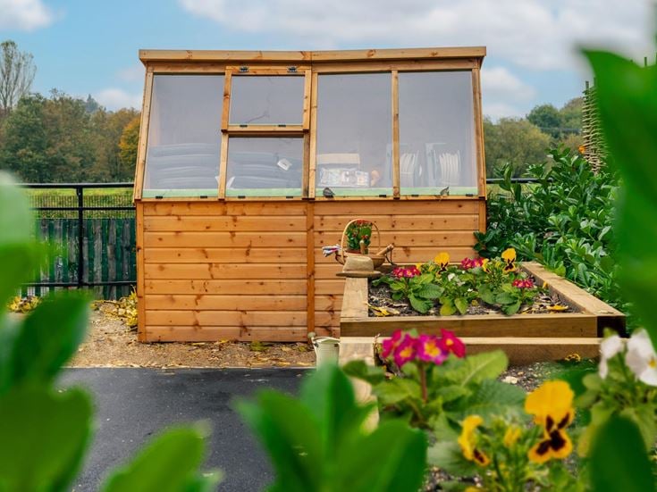 a small wooden structure in a garden