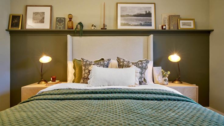 a bed with a green bed spread