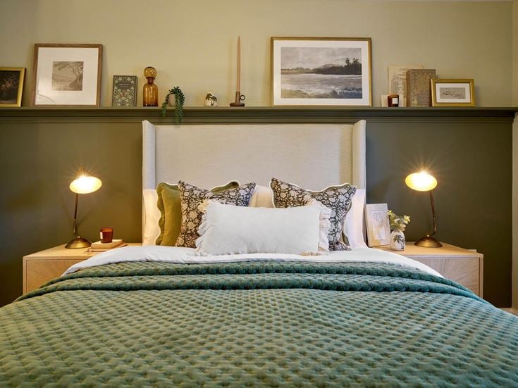 a bed with a green bed spread