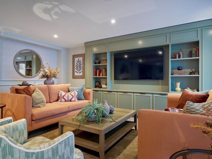 a living room with a tv and couches