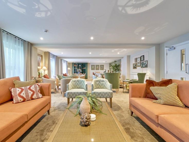 a large living room with a large chandelier and a large glass door