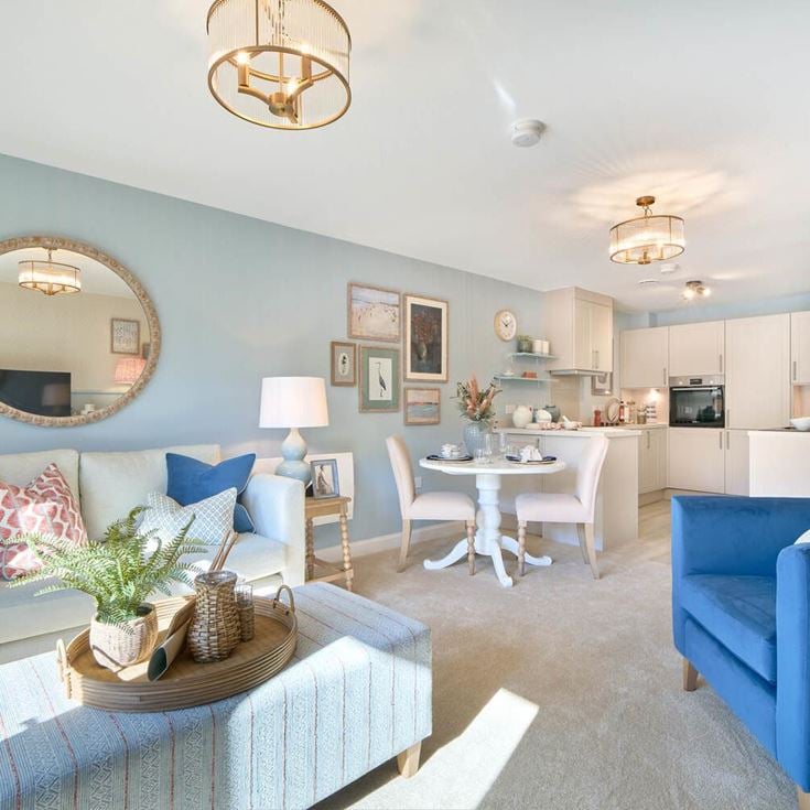 a living room with a blue couch and a table