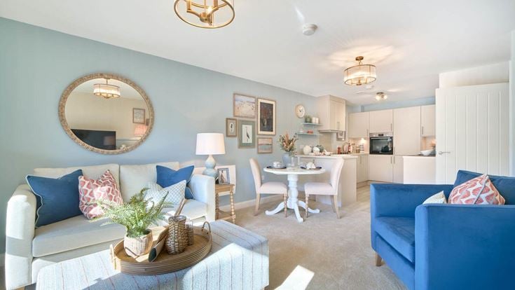 a living room with a blue couch and a table