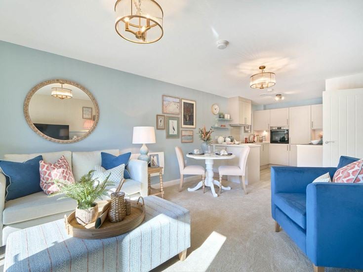a living room with a blue couch and a table