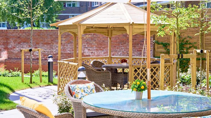 a patio with a table and chairs