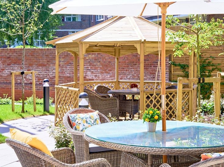 a patio with a table and chairs