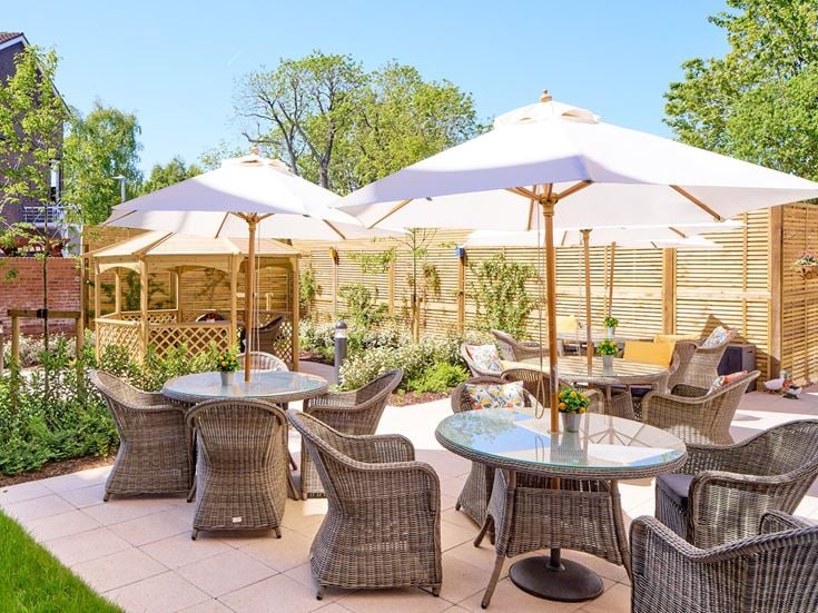 a patio with tables and chairs
