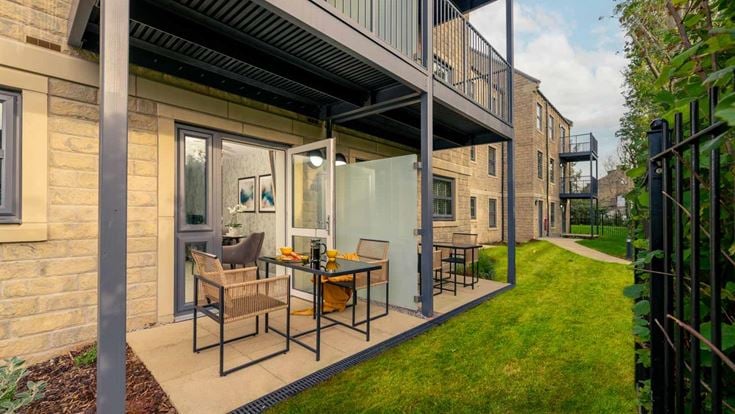 a patio with a table and chairs outside of it