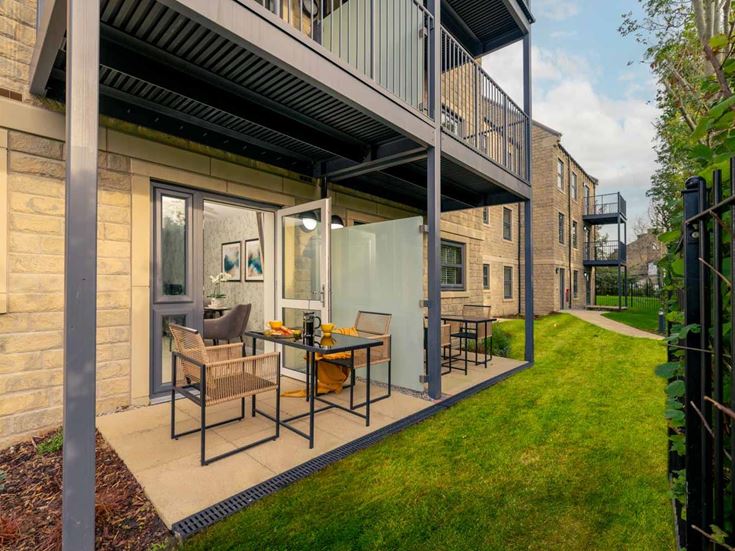 a patio with a table and chairs outside of it