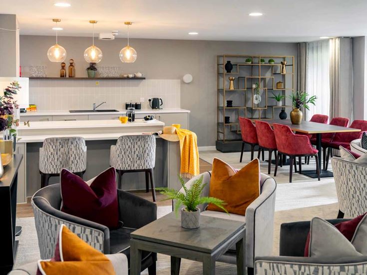 a living room with a kitchen and dining area