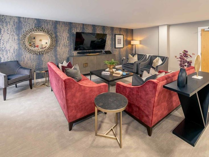 a living room with a red couch and a coffee table