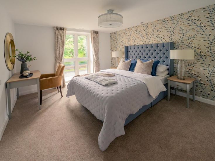a bedroom with a bed and a desk