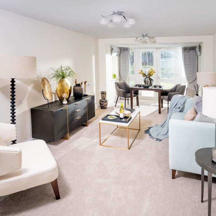 a living room with white furniture