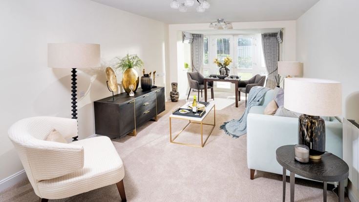 a living room with white furniture