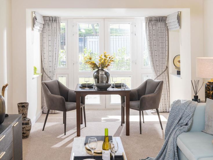 a living room with a table and chairs