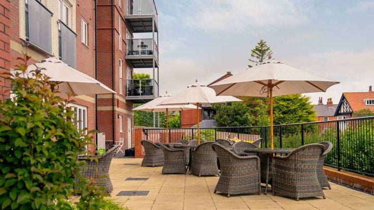 a patio with chairs and umbrellas