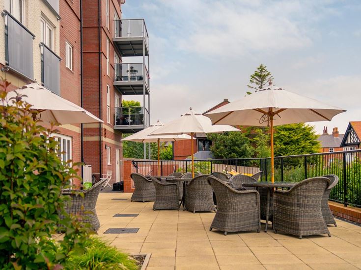 a patio with chairs and umbrellas