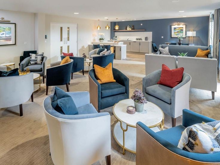 a living room with a large table and chairs