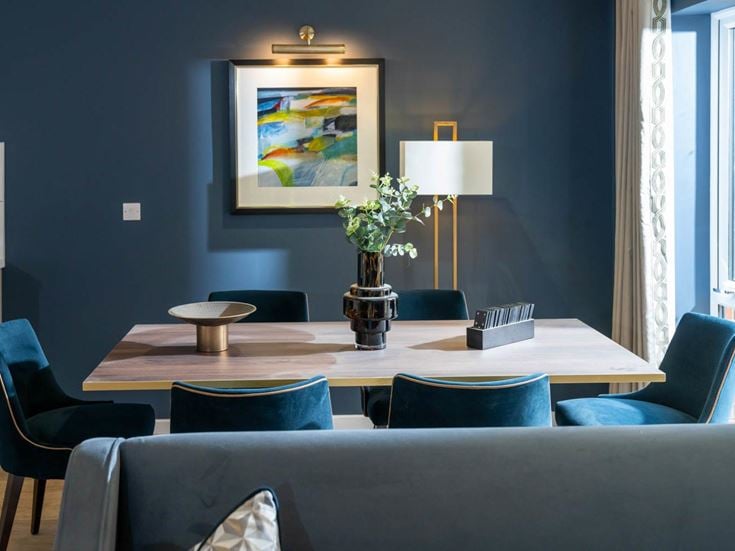 a living room with a table and chairs