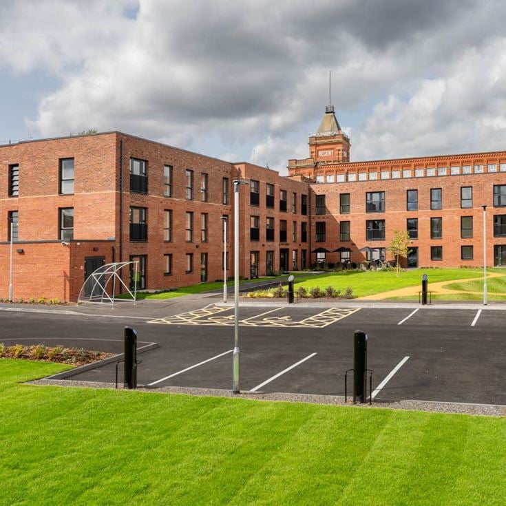 a large brick building with a parking lot in front of it