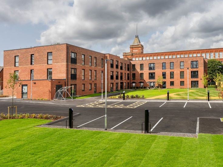 a large brick building with a parking lot in front of it