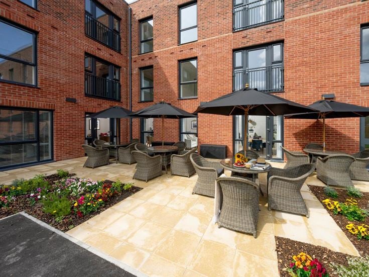 a patio with chairs and umbrellas