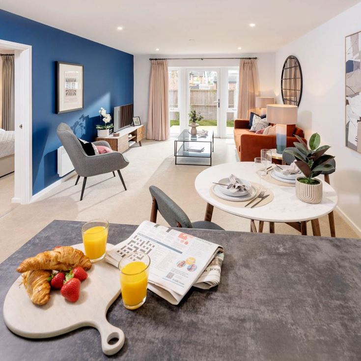 a living room with a bed and a table