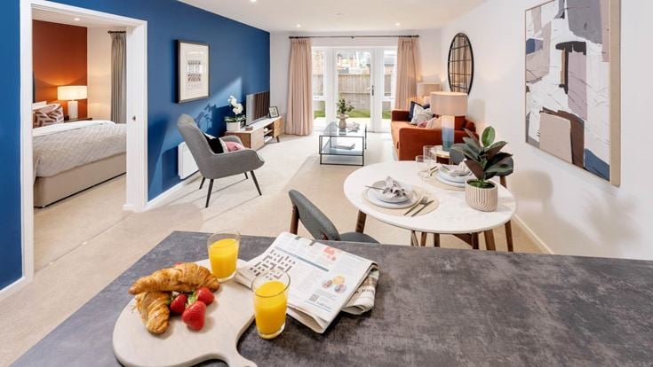 a living room with a bed and a table