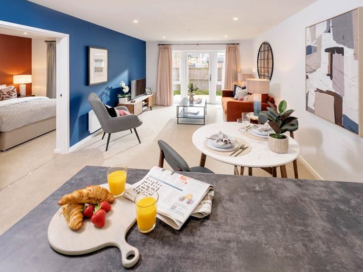 a living room with a bed and a table